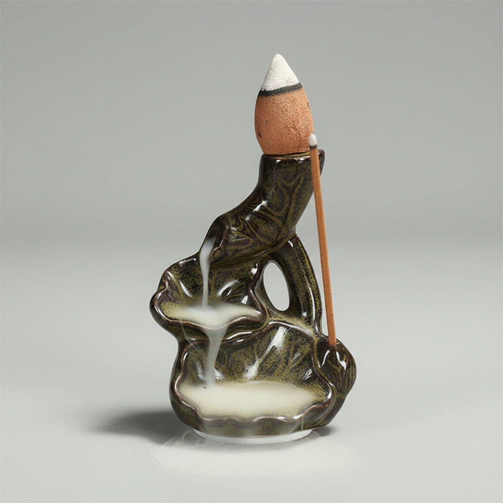 Ceramic incense burner with backflow incense on a dark background
