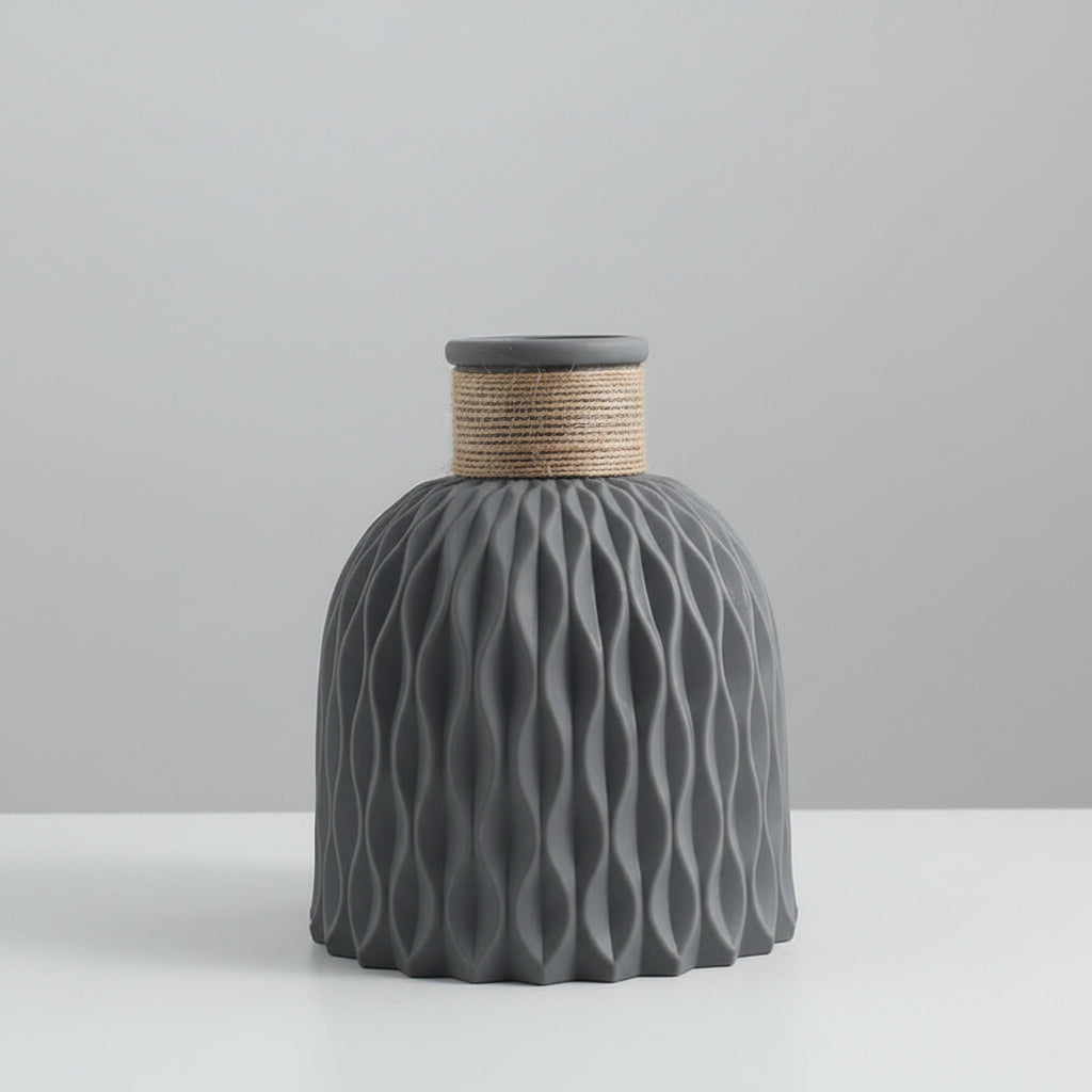 Gray textured vase with wavy pattern on a light gray background